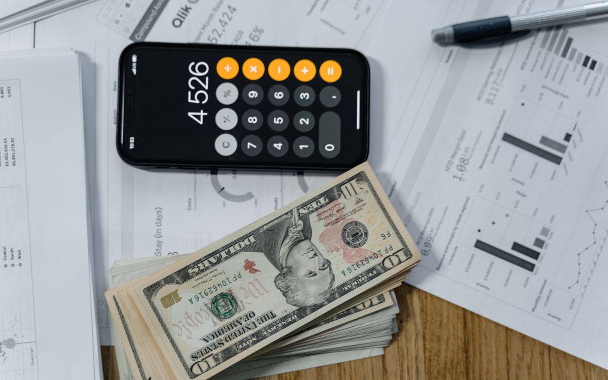 A calculator and cash on financial documents