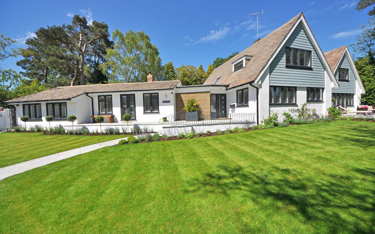 A large two-storey house with a manicured lawn